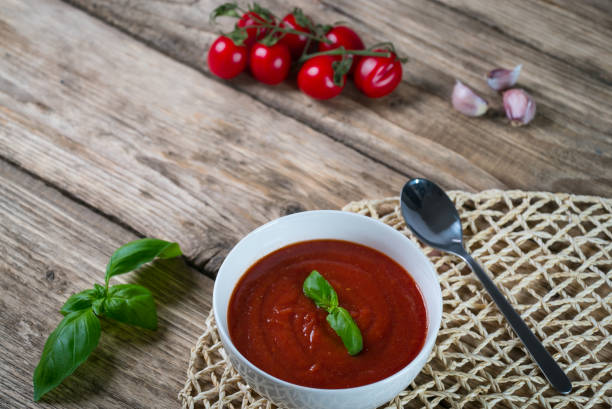 istock Tomato soup on wooden table, top view 854582388