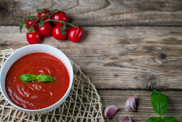 istock Tomato soup on wooden table, top view 854582508
