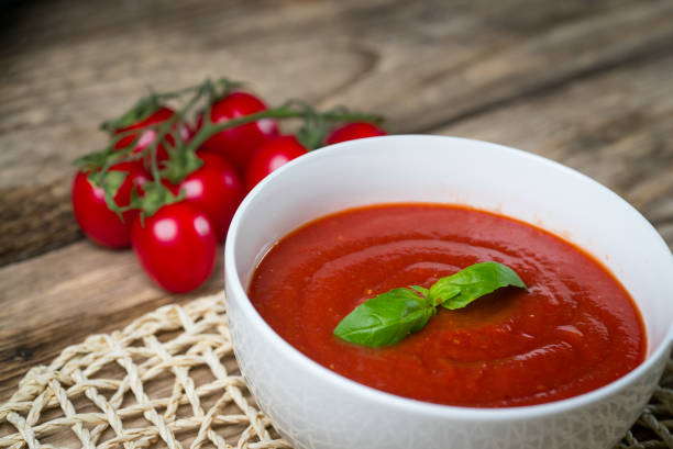 istock Tomato soup on wooden table, top view 854582558