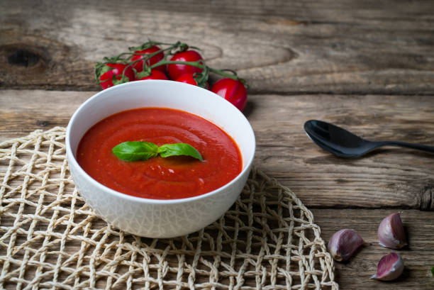 istock Tomato soup on wooden table, top view 854582604