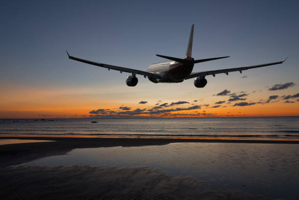 istock Airplane flying in sky with clouds at sunset 854582632