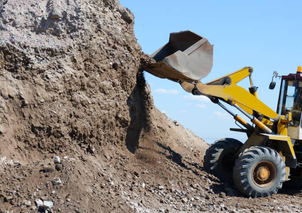 istock Wheel excavator digging  gravel pile 854583376