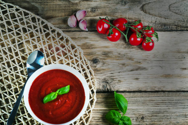istock Tomato soup on wooden table, top view 854583512