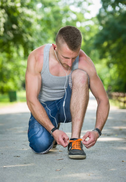 istock runner man tie shoe on a road in a park 854589826