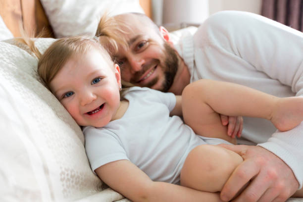 istock Father with adorable baby toddler on bed 854589982