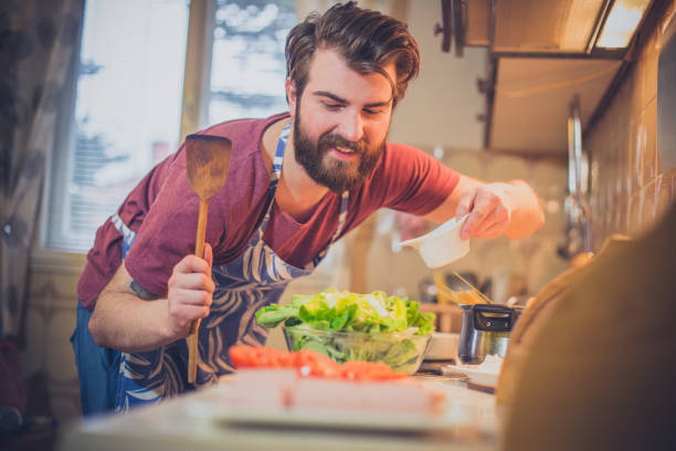 istock Handsome bearded man making healthy meal in the kitchen 854589990