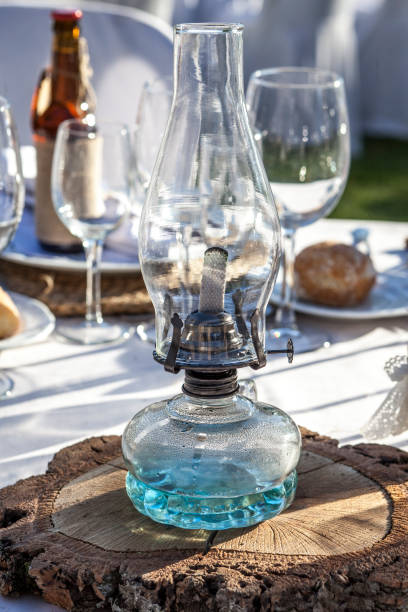 istock Rustic kerosene lamp over log cut as a wedding centerpiece table 854590134