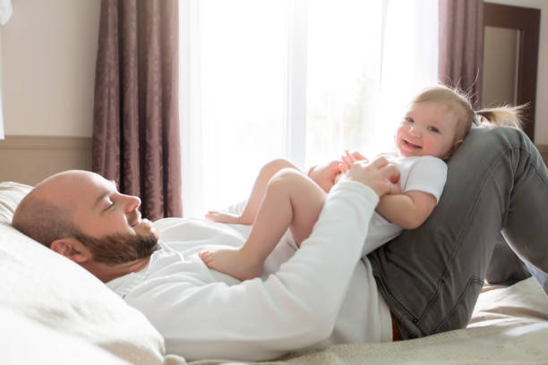 istock Father with adorable baby toddler on bed 854592900
