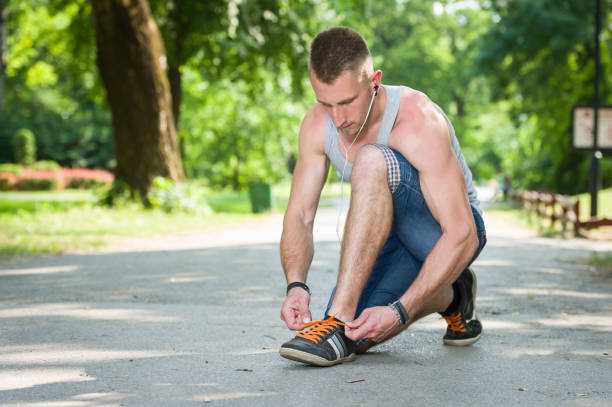 istock runner man tie shoe on a road in a park 854592916