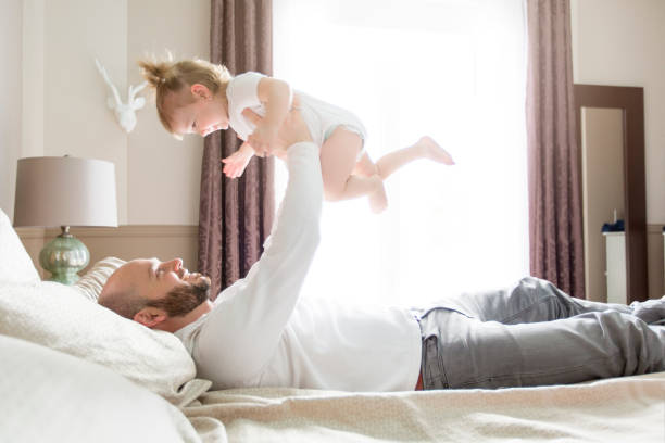 istock Father with adorable baby toddler on bed 854593092