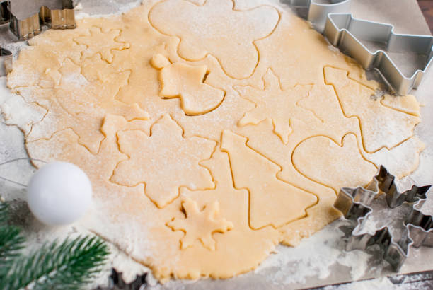 istock Cutting the gingerbread cookie dough for Christmas and New Year 854595404