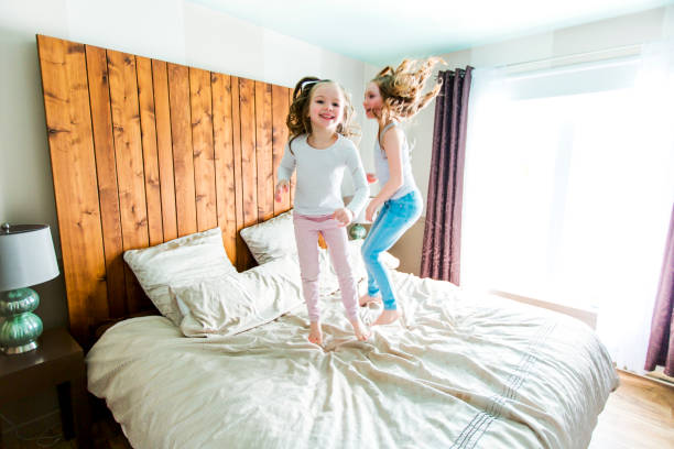 istock two sister lay bed at home 854600892