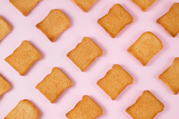 istock Slice of Toasted Bread on Pink Background 854600936