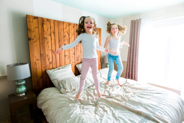 istock two sister lay bed at home 854600974