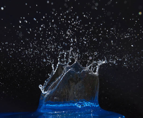 istock Splash of water crown on blue surface. 854602206