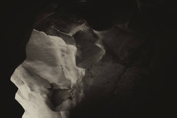 istock Black and white image of beautiful textured cave wall 854609740