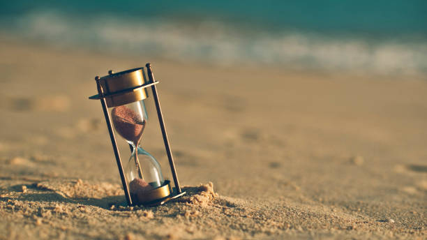 Vintage Photos Hourglass On Sand Beach vintage nature stock pictures, royalty-free photos & images