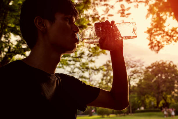 istock Man drinks water for health 854625640