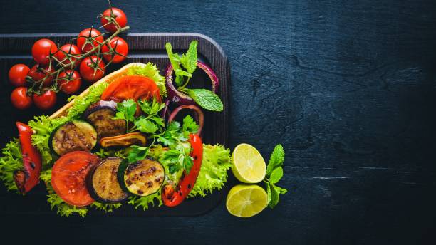 istock Bruschetta with grilled vegetables, olives, herbs and parmesan cheese on bread. Cold snacks. Italian cuisine. On Wooden background. 854635756