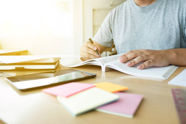 istock Close up of studying student hands writing in book during lecture education students college of university, Reading, Learning and Exam. Education concept 854635770