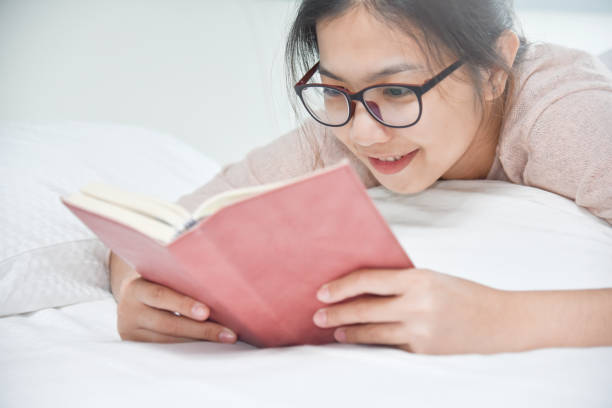 istock Happy Beautiful Asian woman reading book. 854643800