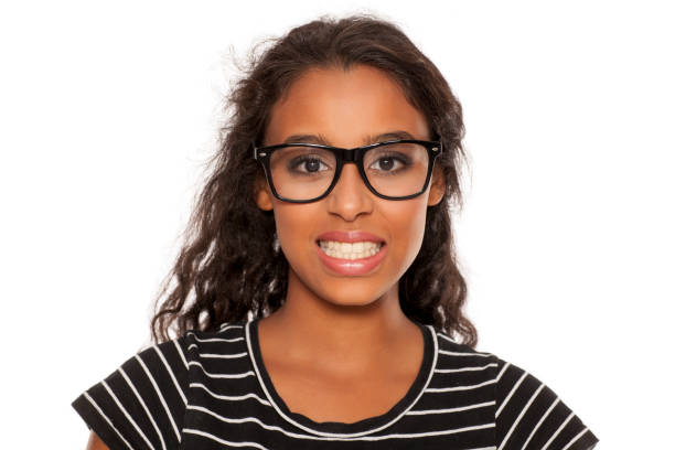 istock beautiful young dark skinned woman with forced smile 854646624