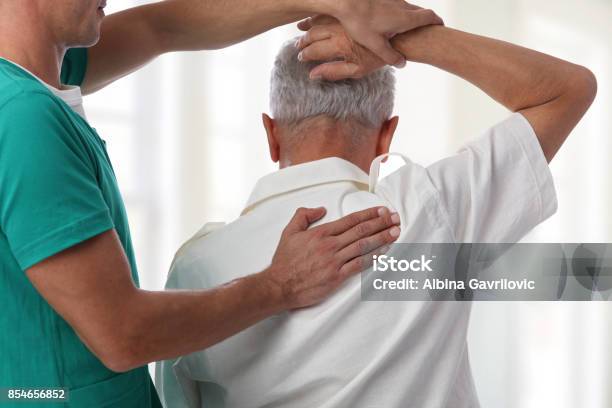 Senior Man Having Chiropractic Back Adjustment Osteopathy Physiotherapy Pain Relief Concept Stock Photo - Download Image Now