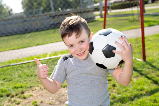 istock Young caucassian soccer player football 854657468