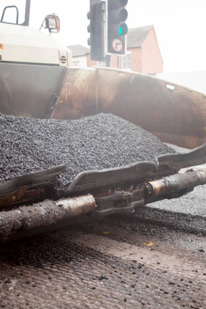istock a roadworks on the street new asphalt with worker 854658068