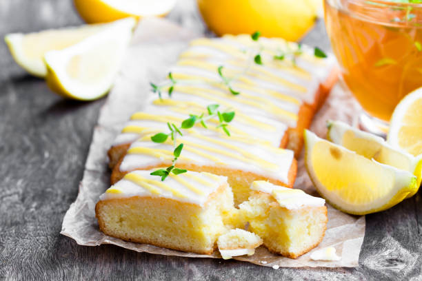 istock Lemonloaf  cake sliced on baking paper with green herb tea 854663614