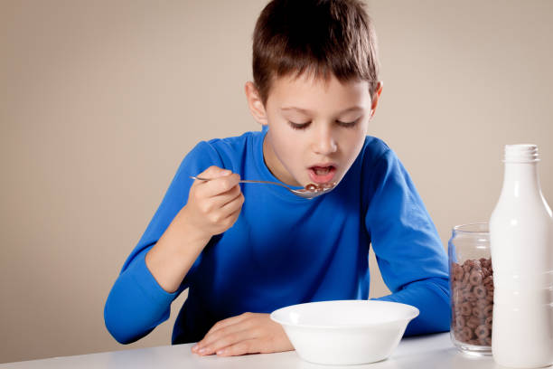 istock Child eating chololate cereals with milk for breakfast 854668530