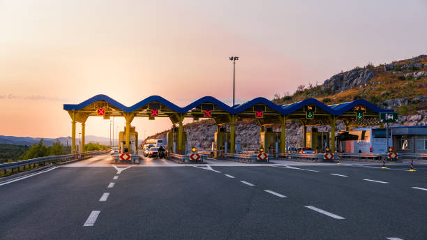 Cars passing through the toll gate on the motorway, vivid travel background stock photo