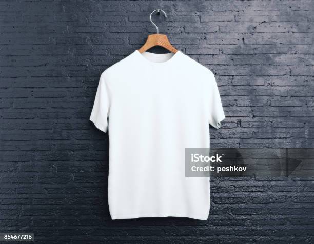 White Tshirt On Brick Background Stock Photo - Download Image Now - T-Shirt, White Color, Coathanger