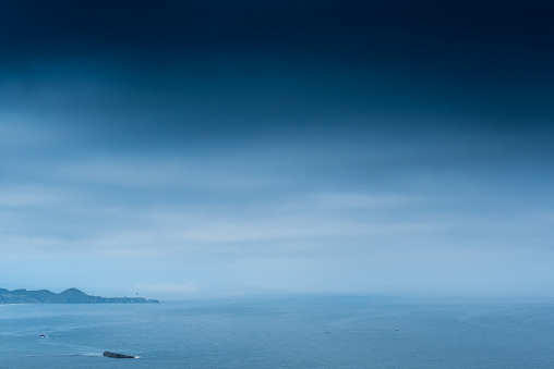 Dark Cloudy Sky Above Yaquina Head Lighthouse and the Oregon coast