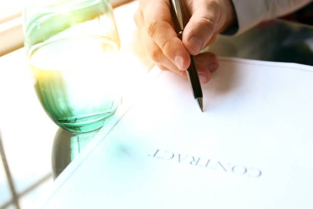 istock business man is signing a contract sitting in the office 854681892