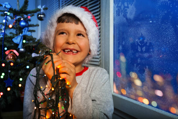 istock Little laughing boy hold New Year garland 854681912