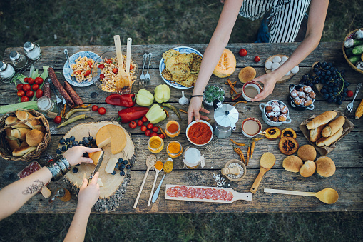 Overhead image of various homegrown food, vegetables and meat, on an old wooden table. Healthy eating. Organic foods in the outdoors.