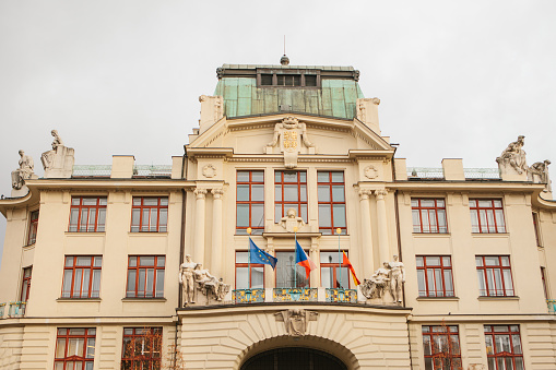 New Town Hall on the eastern side of the Mariinsky Square in Prague in the Czech Republic. Municipal building. Hanging flags on the entrance.
