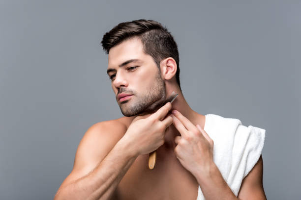 istock man shaving with straight razor 854714116