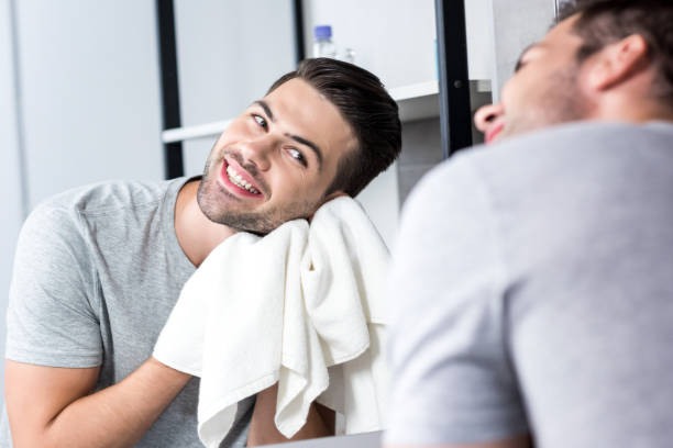 istock man wiping face with towel 854722348