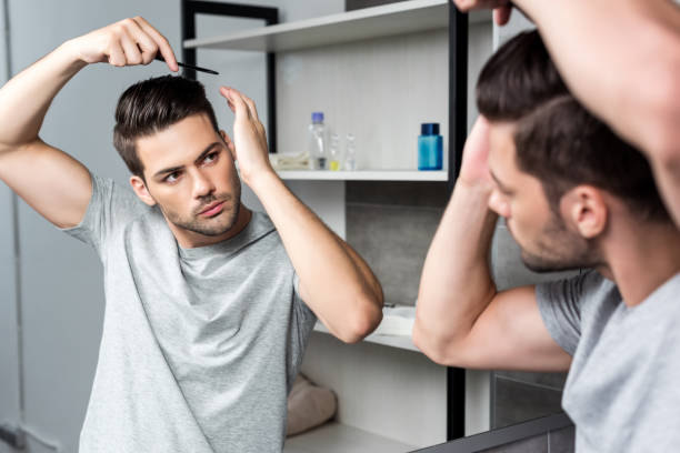 istock young man brushing hair 854723136
