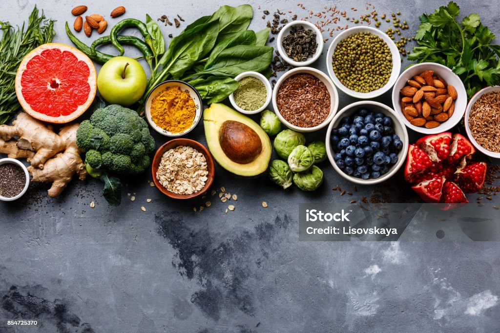 Healthy food clean eating selection Healthy food clean eating selection: fruit, vegetable, seeds, superfood, cereals, leaf vegetable on gray concrete background copy space Vegetable Stock Photo