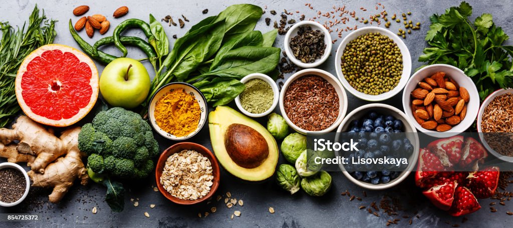 Healthy food clean eating selection Healthy food clean eating selection: fruit, vegetable, seeds, superfood, cereal, leaf vegetable on gray concrete background Healthy Eating Stock Photo