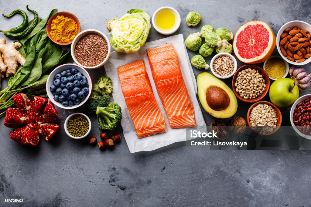 Healthy food clean eating selection Healthy food clean eating selection: fish, fruit, vegetable, seeds, superfood, cereals, leaf vegetable on gray concrete background copy space Healthy Eating Stock Photo