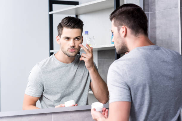 istock man applying facial cream 854725654