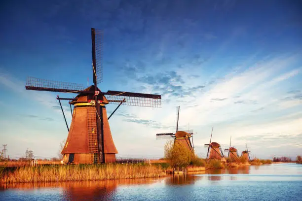 Photo of The road leading to the Dutch windmills from the canal in Rotterdam. Holland. Netherland