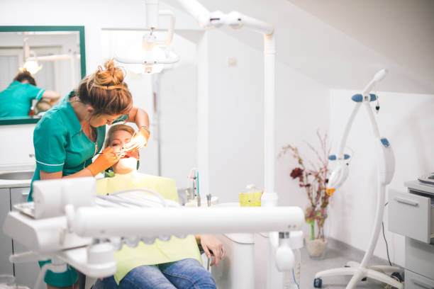 istock Woman dentist working at her patients teeth 854726054