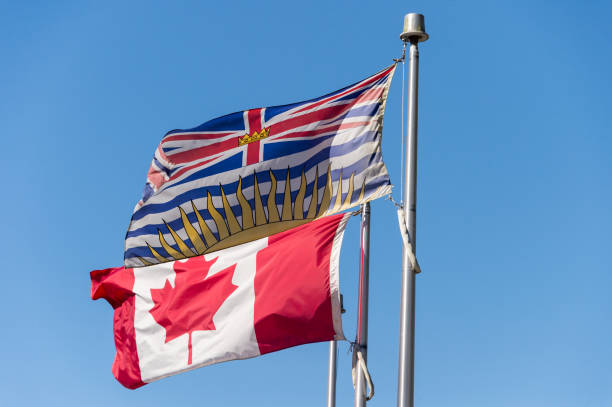 British Columbia flag waving over blue sky in Vancouver, BC, Canada stock photo