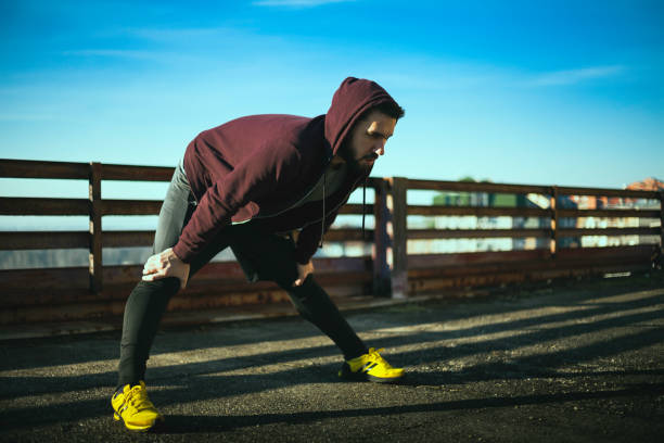 istock Sporty young man stretching 854740478