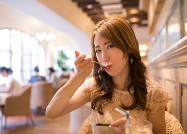 istock Happy woman eating cake in restaurant 854741048